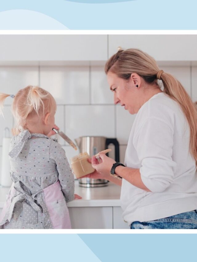 Mother preparing food with her young daughter in the kitchen, balancing everyday parenting responsibilities while caring for her family.