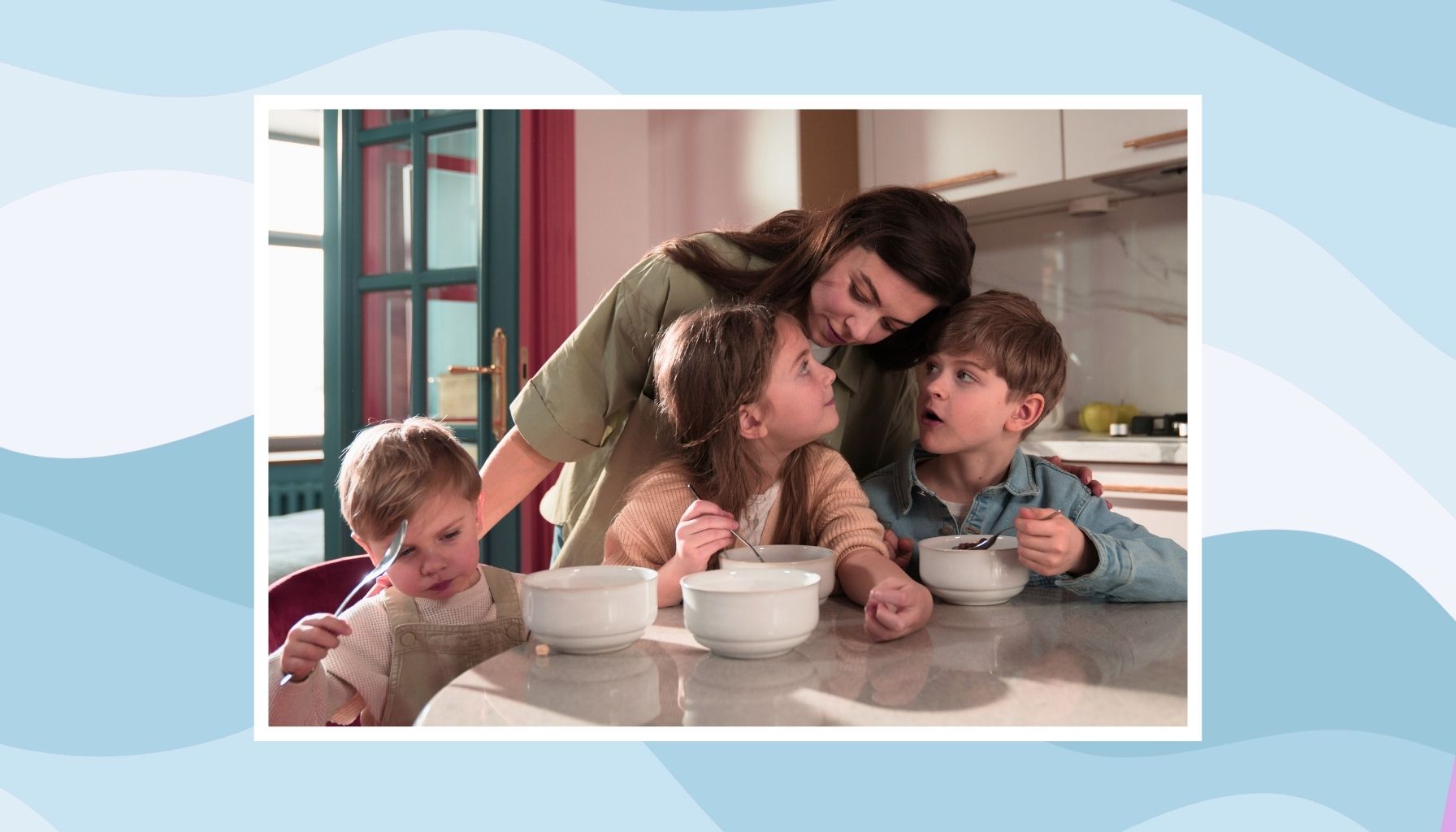 Mother baking with two young children at a kitchen table during a busy family moment.