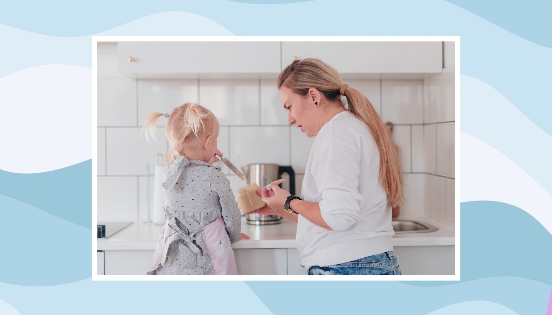 Mother preparing food with her young daughter in the kitchen, balancing everyday parenting responsibilities while caring for her family.