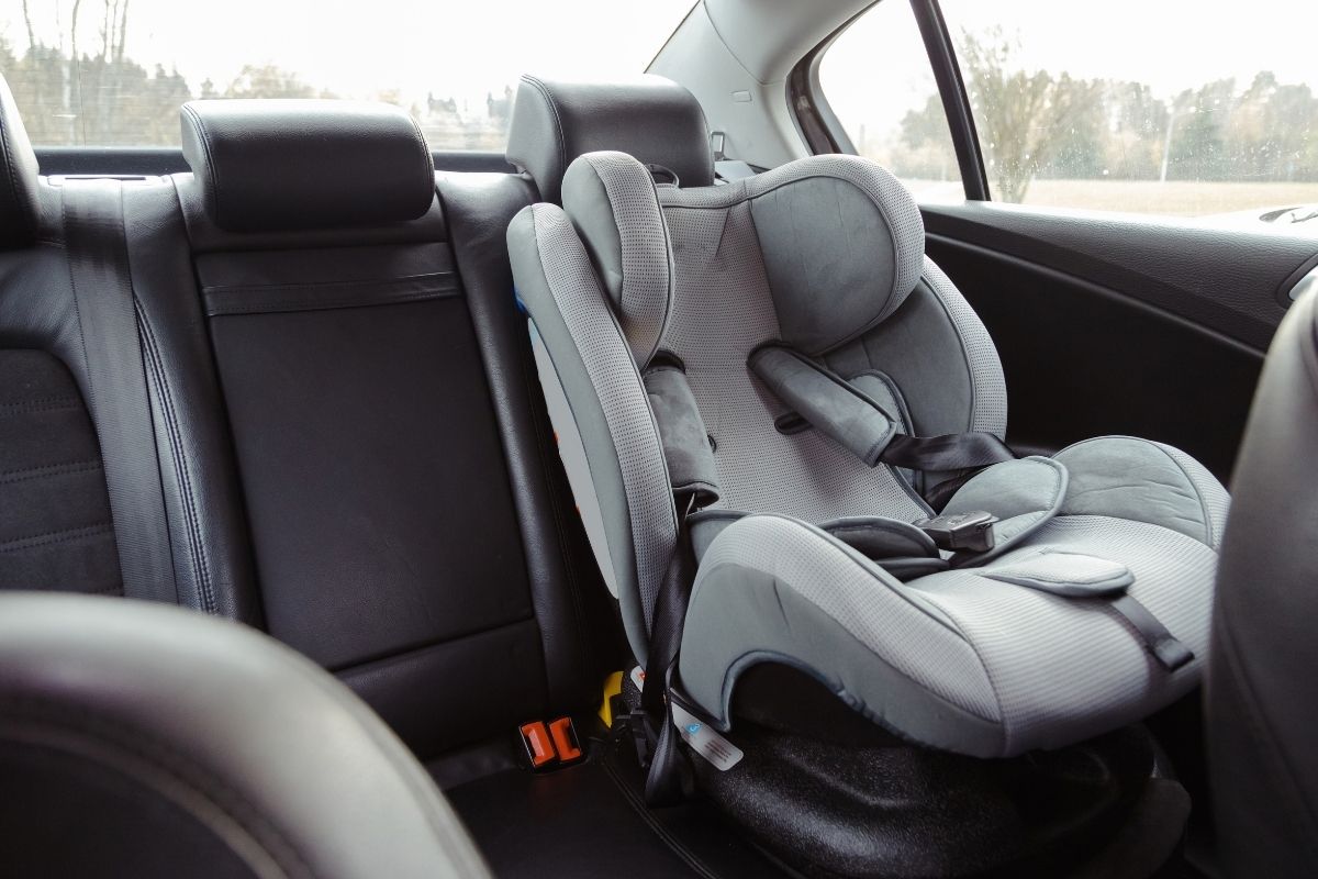 Child car seat installed in the back seat of a car.